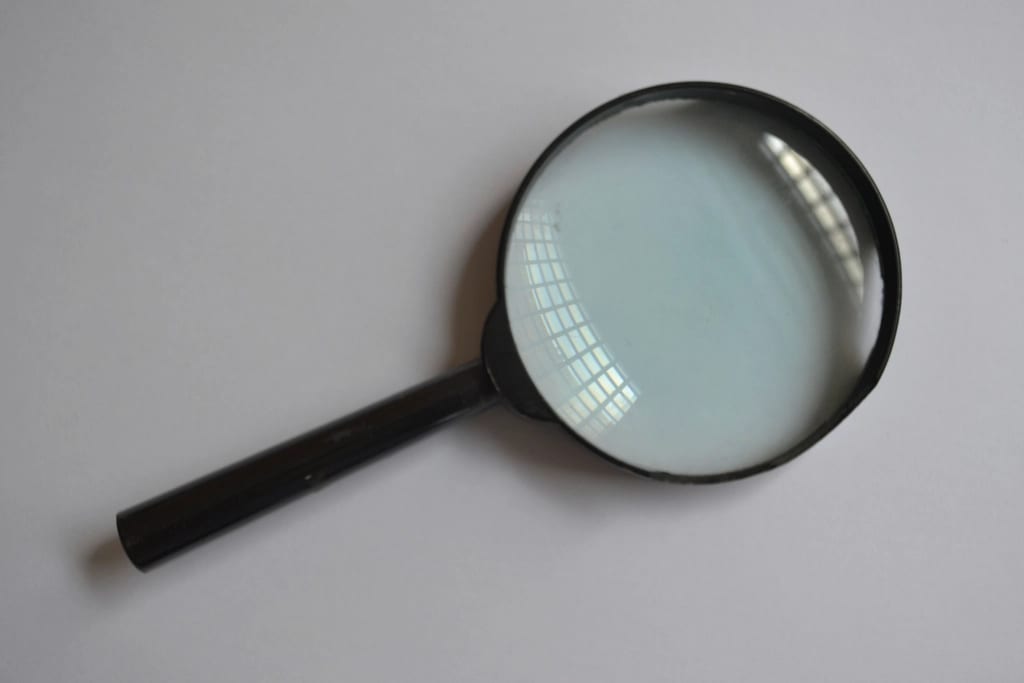 A magnifying glass on a plain surface